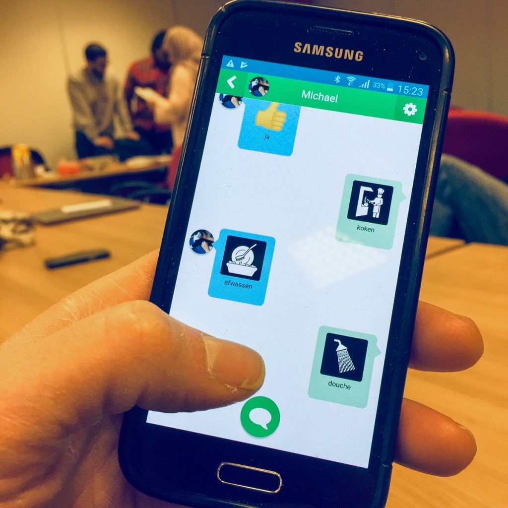 Foto Samsung-telefoon met chat-app Pictostudio Hallo tijdens test met cliënten en begeleiders.